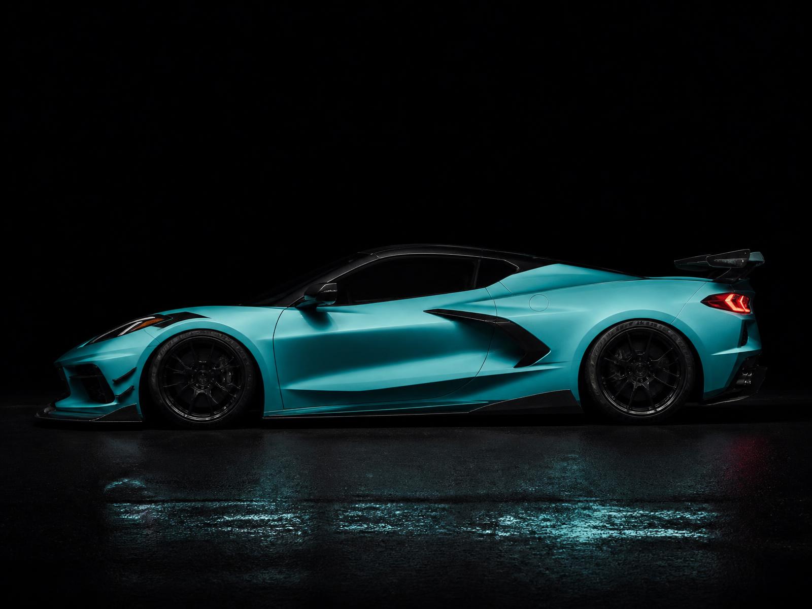 Side profile of the Tiffany-blue widebody C8 Corvette in dramatic dark lighting